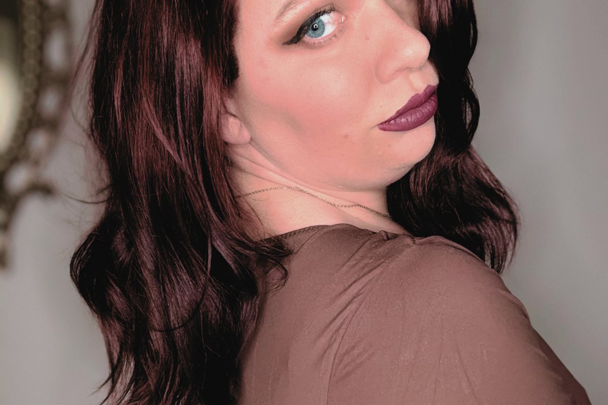 Portrait of writer Mackenzie turning towards the camera.